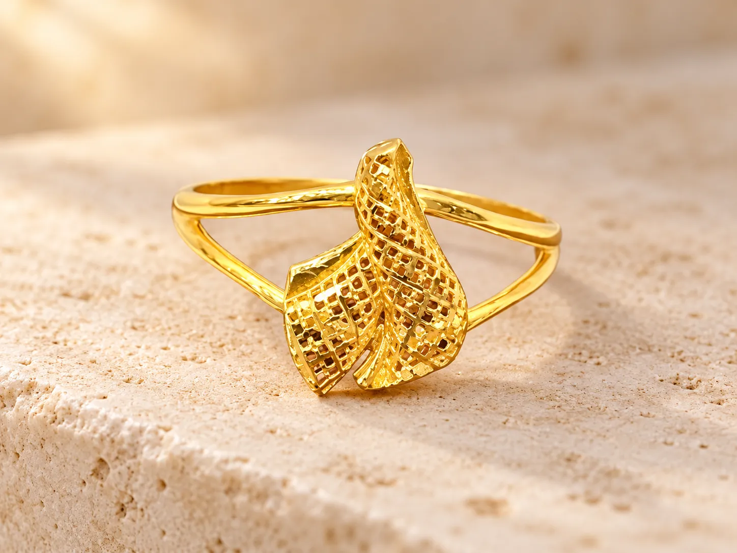 Gold ring with a twisted, textured knot at the front