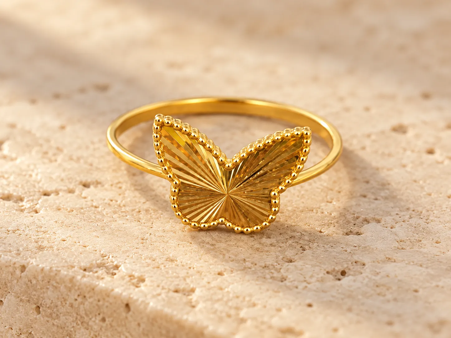Slim gold ring with a butterfly at the front